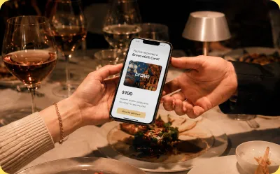 Hand holding a phone showing Bravo eGift card